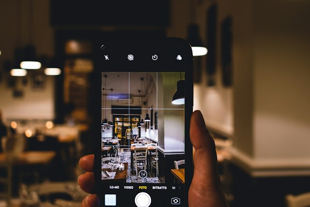 Person using a smartphone camera to frame a photograph